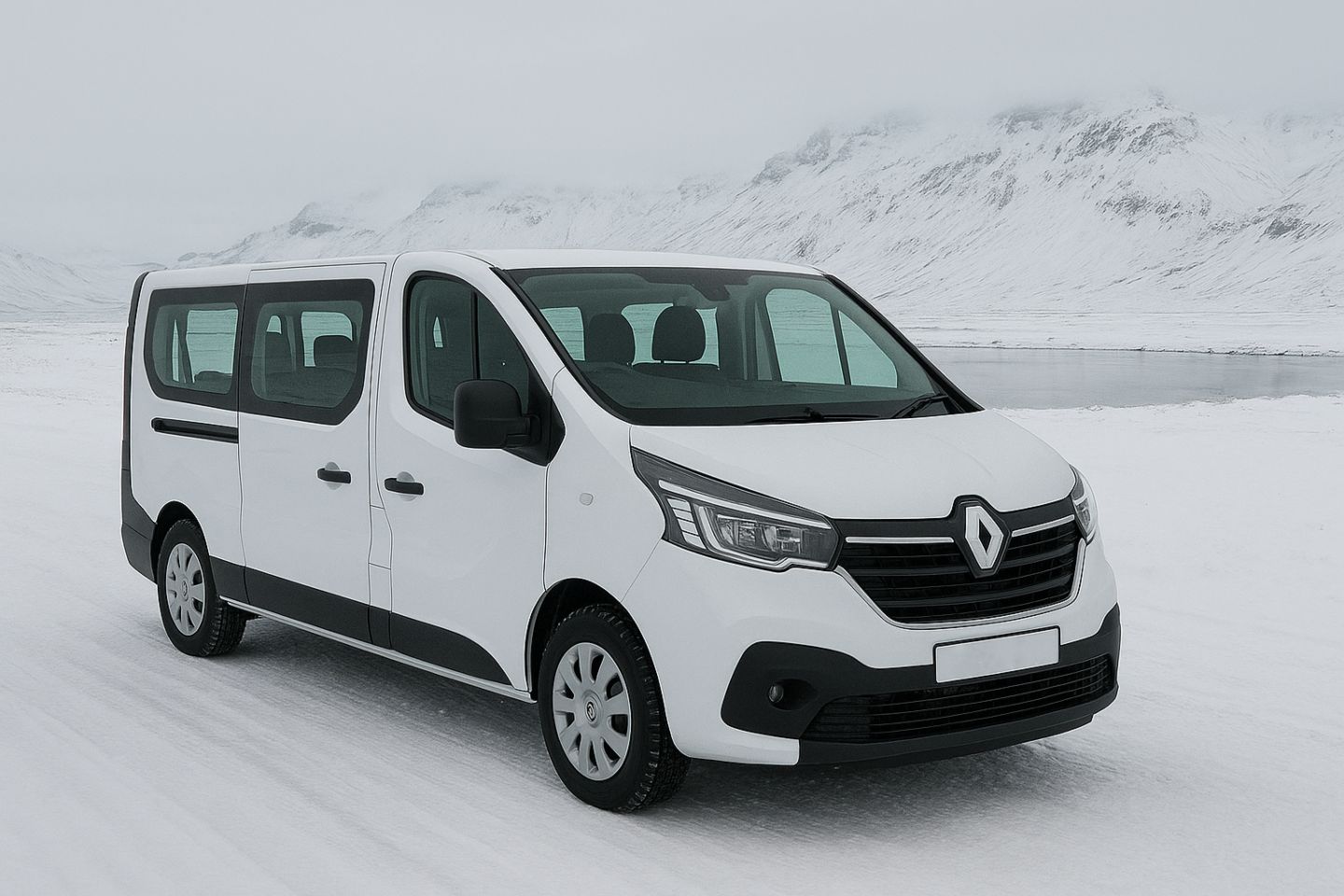 White Renault parked on the snowy field next to the water and mountains