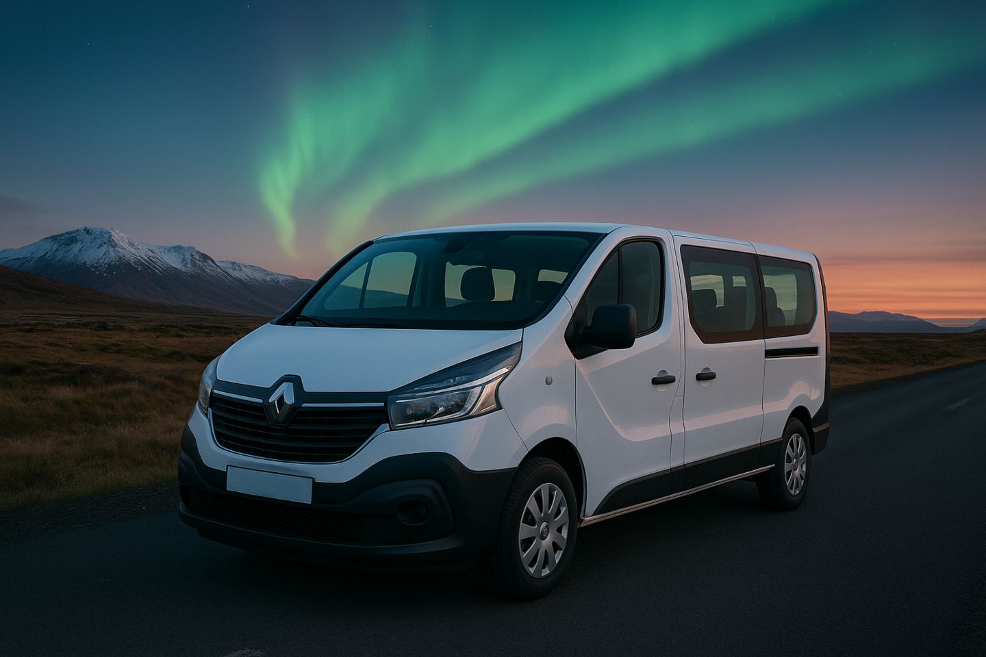 White Renault parked on the paved road next to the yellow-brown fields, and the mountains partially covered by the snow. There are the Northern Lights in the sky